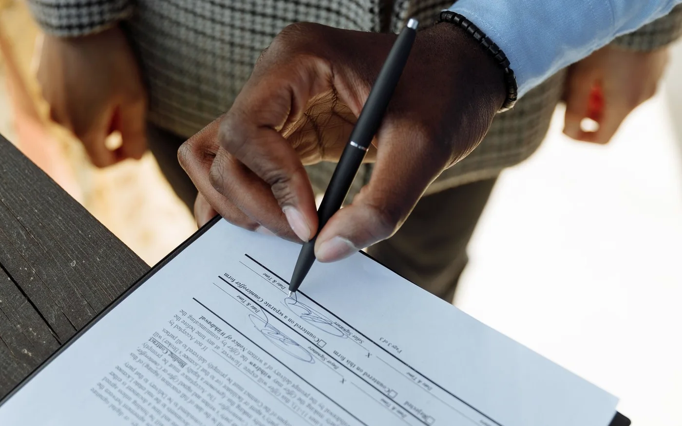 An executed contract outranks a draft, and the answer cites it