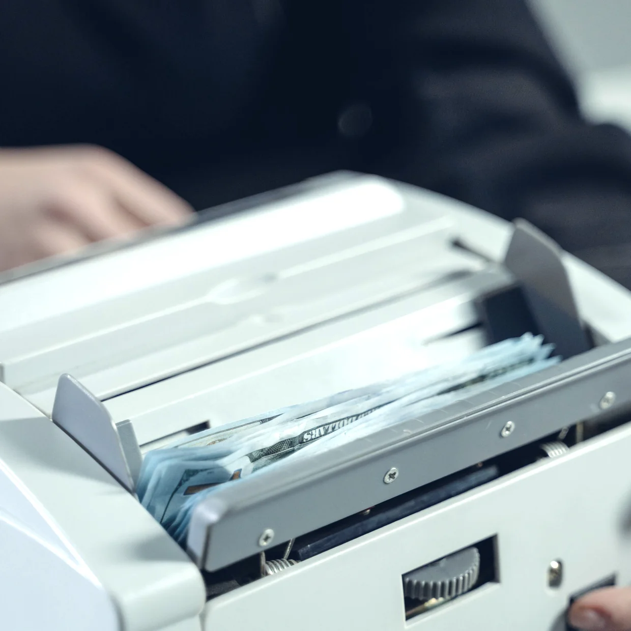 A shredder cutting a document into strips.
