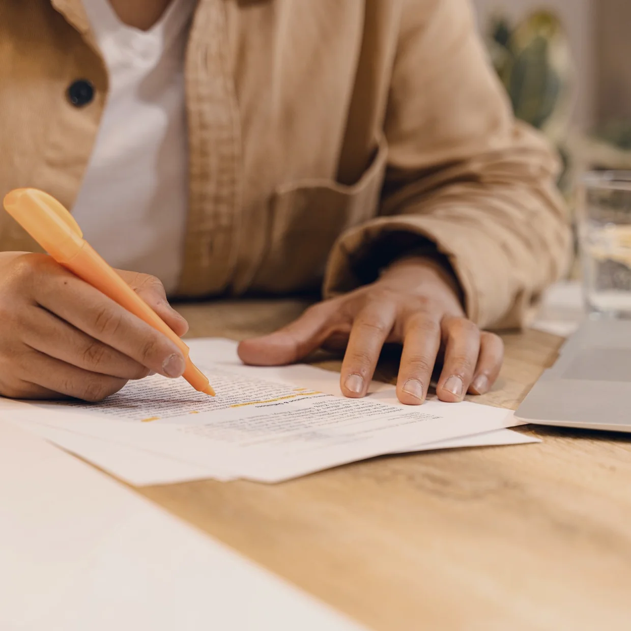 A hand marking a correction on a printed document.