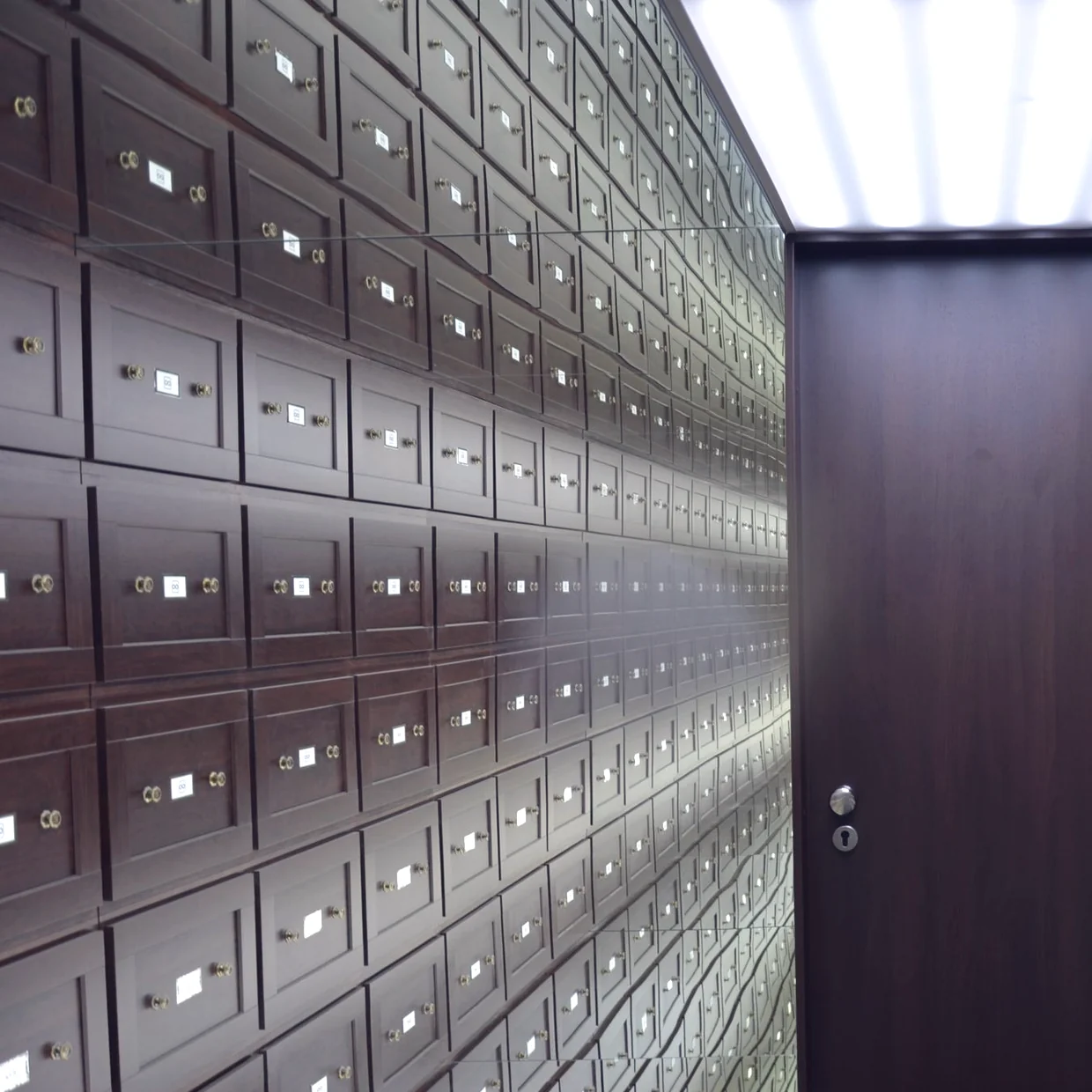A wall of individually keyed lockboxes.
