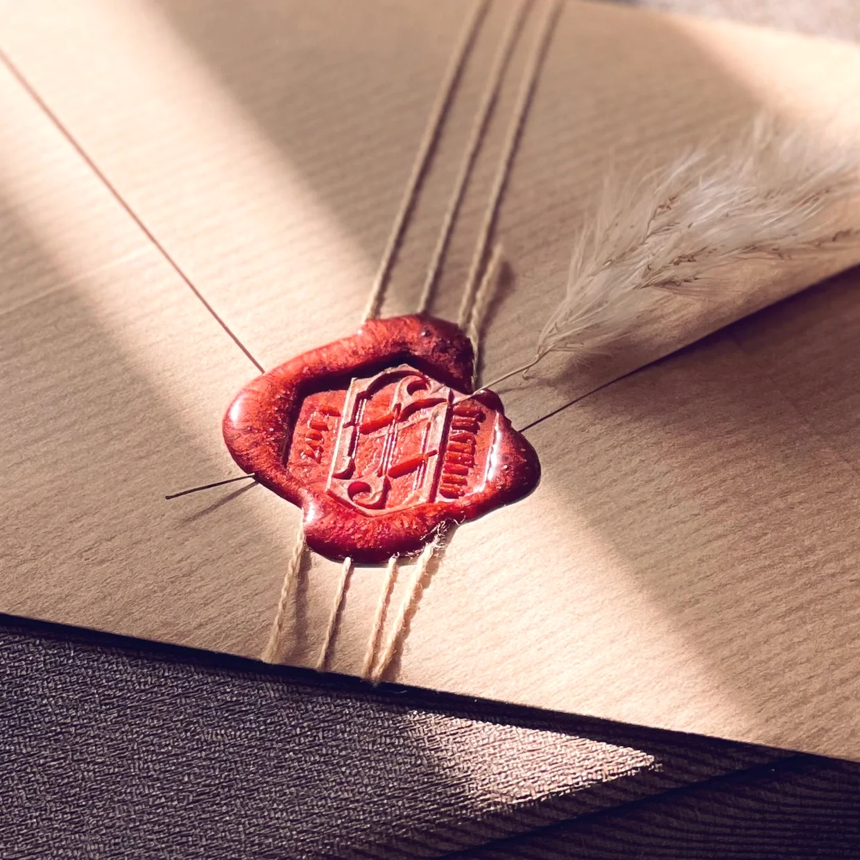 A red wax seal closing an envelope.